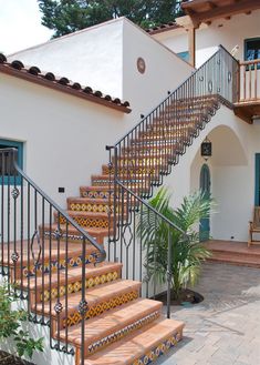 a house with stairs leading up to the front door