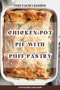 chicken pot pie with puff pastry in a white casserole dish on a table