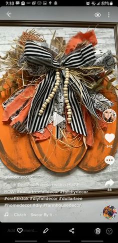 an orange pumpkin decorated with black and white ribbons