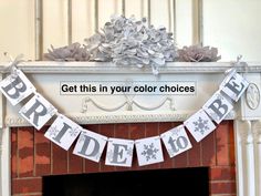 a bride and groom banner hanging from a fireplace mantel above a mantle with flowers