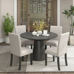 a dining room table with four chairs around it