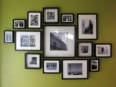 a green wall with black and white pictures on it