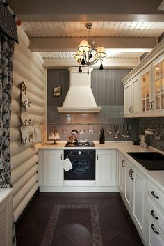 a kitchen with an oven, sink and stove top oven in it's corner