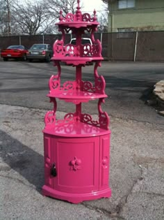 a pink fire hydrant sitting on the side of a road