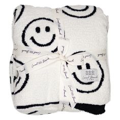 a smiley face towel wrapped in white and black