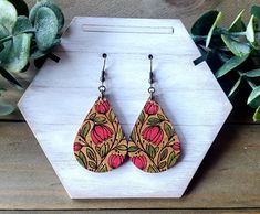 a pair of wooden earrings sitting on top of a table