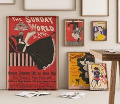 an old fashion poster hangs on the wall next to several other vintage posters and frames