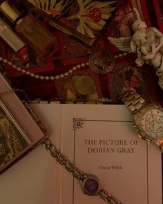 a book and watch on a table with other items