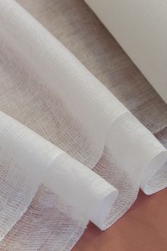 white sheer fabric on top of a wooden table