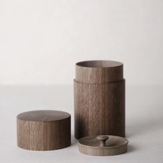 two wooden containers sitting next to each other on a white surface with the lid open