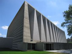 the building is made out of concrete and has an unusual design on it's side