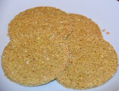 three crackers on a white plate ready to be eaten and put in the oven