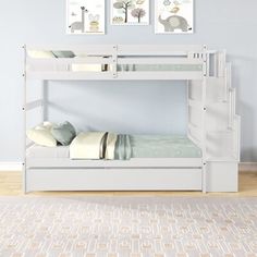 a white bunk bed with two pictures above it