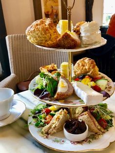 three tiered trays filled with food on top of a table