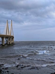 a bridge over the ocean on a cloudy day