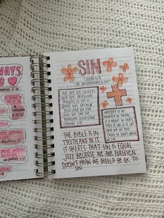 two notebooks with writing on them sitting next to each other