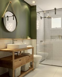 a bathroom with green walls and white tile