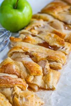 an apple pie next to a green apple