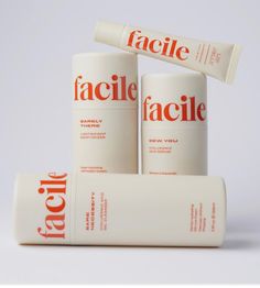 three tubes of facial care sitting next to each other on a white surface with the word facile written in red