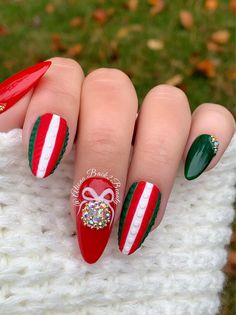 "Green and Red Christmas Press on Nails Model: Medium almond Please read full description below. This set features:  Bling ornament on middle finger Bling accents on thumb and pinky Textured sweater design on index and ring finger Glossy and matte finish I offer quality handcrafted press on nails designed with quality gel polish. This set will give you a perfect manicure within a few minutes for a small portion of the salon cost.  Sets come with 10 nails (based on the size/shape selected), nail Red Green And Gold Christmas Nails, Red And Green Sweater Nails, Christmas Nails Red Green Gold, Christmas Nails Red Green, Green And Red Christmas Nails, Crazy Christmas Nails, Green Present Nails, Red And Green Sparkle Nails, White Nails With Red And Green Glitter