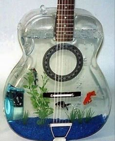 a glass guitar shaped like a fish tank with the words sarah written on it