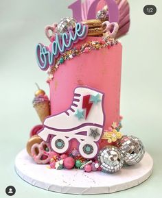 a pink birthday cake with roller skates and ice cream cones on the bottom tier