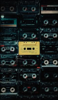 there are many cassettes stacked on top of each other in this room, and one is yellow