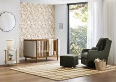 a living room with a baby crib and chair