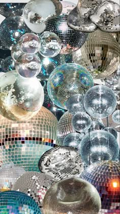 many shiny disco balls hanging from the ceiling