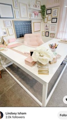 a white desk topped with lots of pink and white flowers