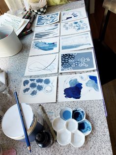 the table is covered with blue and white art supplies