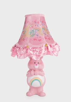 a pink lamp with a bear holding a rainbow