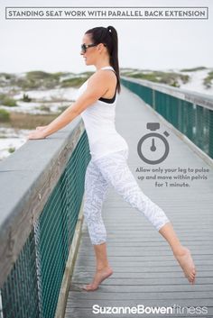 a woman standing on a bridge with her arms outstretched