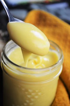 a jar filled with creamy cream next to bananas