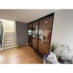 an empty living room with stairs leading to the second floor