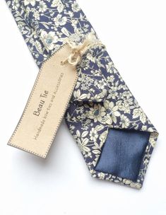 DESCRIPTION: This lovely men's skinny tie has been handmade using a lovely navy blue ditzy floral cotton.FABRIC: Cotton.LINING FABRIC: Silk.--------------------------------------------------------------------------------------------DETAILS:• Made the traditional way with fabric cut on the bias• Each tie has canvas lining throughout• Fabric lining just at the tip on each end of the tie• Width at the widest part measures approx 2.5 inches• The length of each tie is approx 58 Inches• Comes packaged Mens Floral Tie, Wedding Tie, Tie Men's, Wedding Ties, Handmade Bows, Men Fits, Navy Floral, Lining Fabric, Floral Tie