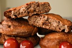 some cookies and cherries are stacked on top of each other