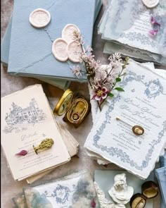 various items are laid out on the ground to be used as wedding cards and stationery