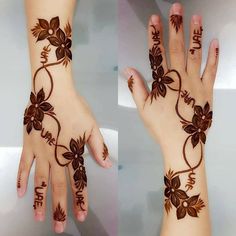 two hands with henna designs on them, one is brown and the other is white