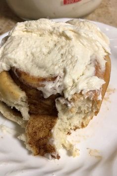 a banana split in half on top of a white plate with cream cheese frosting