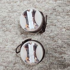 two small round boxes sitting on top of a carpet