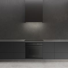 an empty kitchen with grey cabinets and black counter tops is pictured in this image, there are lights on the wall above the stove