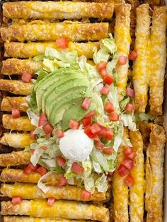 an enchilada with lettuce and tomatoes in a casserole dish