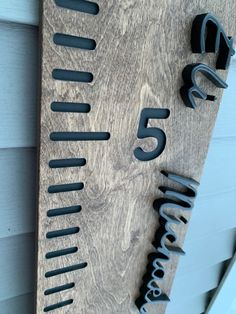 a wooden sign with metal numbers on it