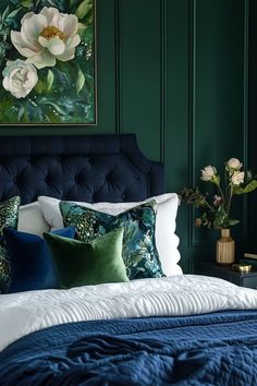 a bedroom with green walls and blue bedspread on the bed is decorated with white flowers