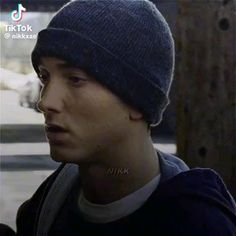 a young man wearing a beanie looking off to the side