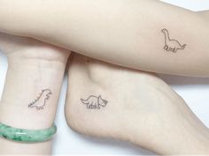 three small tattoos on the arms of two people, one with an animal and one with a dinosaur