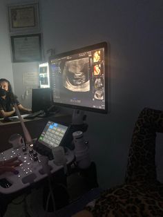 a woman is looking at an x - ray image on her computer screen in the dark