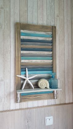 a wooden shelf with starfish and seashells on it