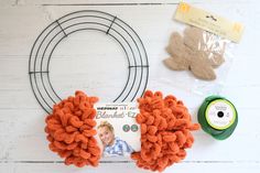 the supplies needed to make an orange wreath